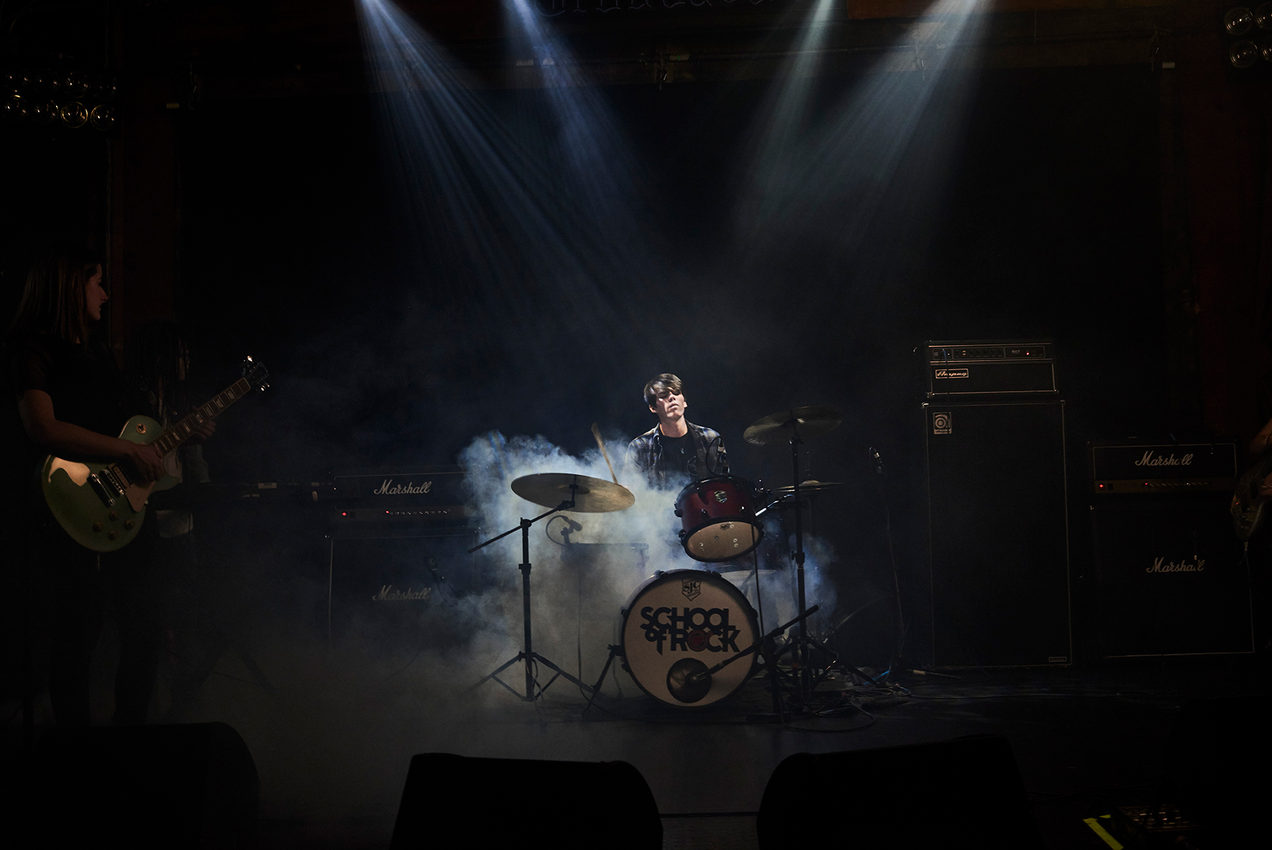 Advanced student learning to play the drums onstage