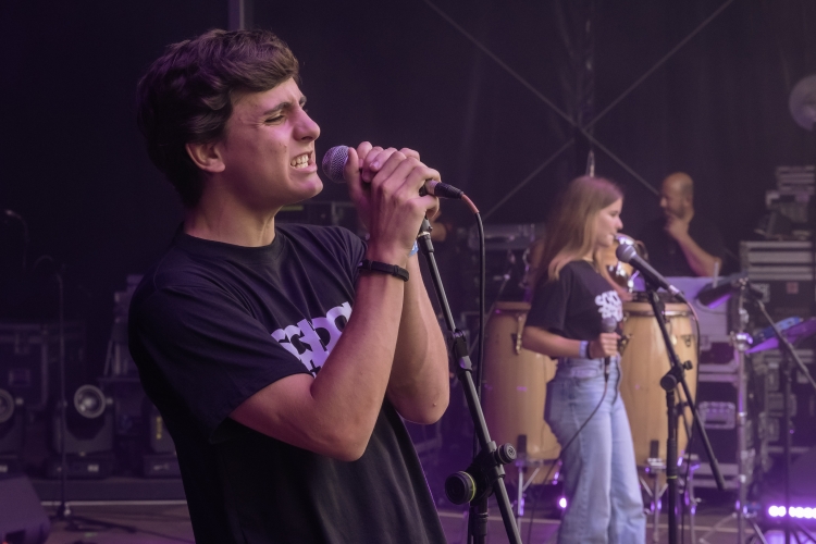 School of Rock student singing on stage