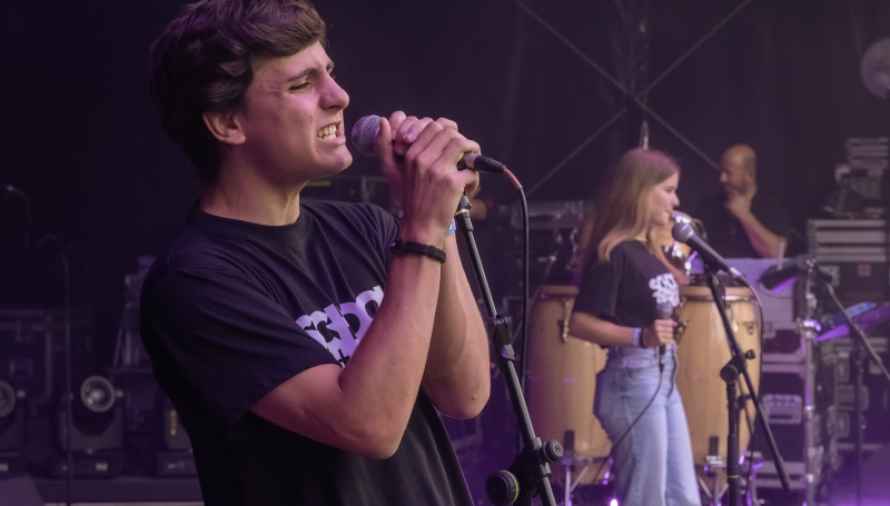 School of Rock student singing on stage