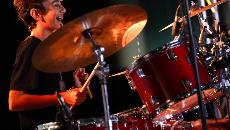 Young boy playing drums