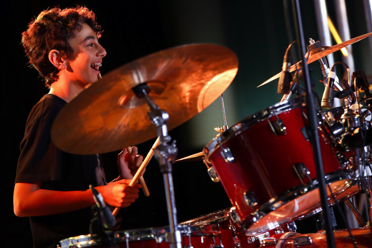 Young boy playing drums