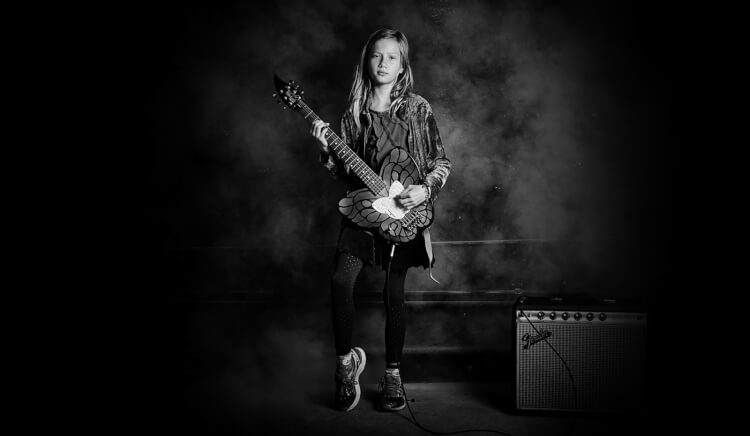 Student playing in music lessons for first graders