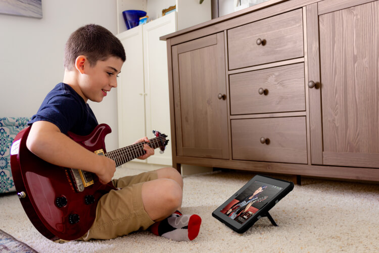 Student playing in online music program for first graders