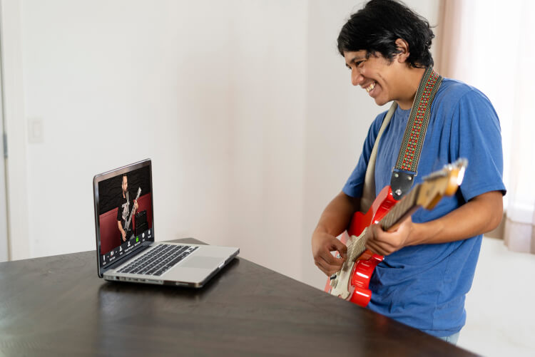 Students playing onstage in School of Rock's Adult Performance Music Program