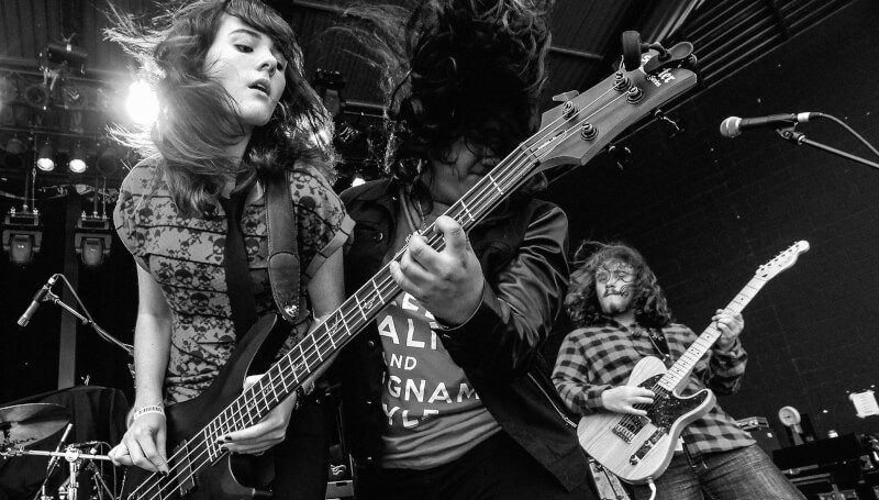 kids playing a bass guitar at a School Of Rock concert